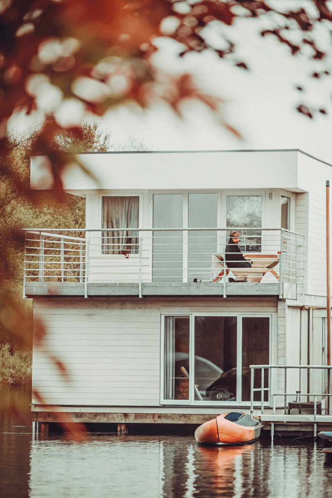 Boathouse escape A tiny boathouse with a large balcony extending over the water The interior is bright with large windows offering views of the lake Kayaks are ready for use right from the front door