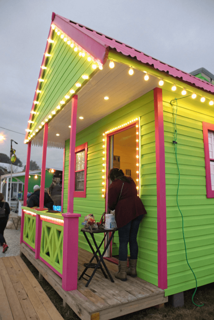 Neon hide Neon tiny house with people around the house