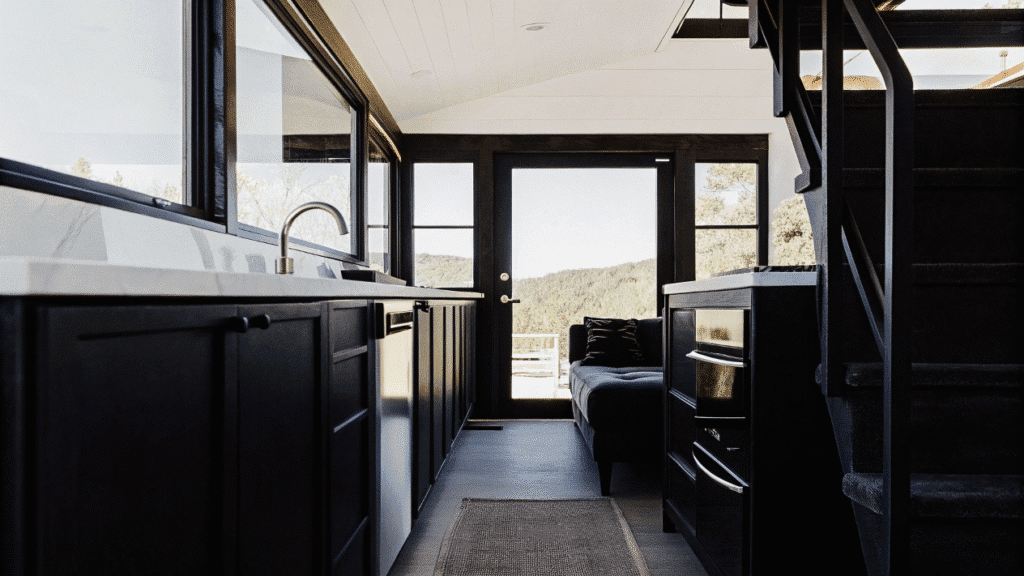 The aurora The interior of a luxurious tiny home featuring a spacious kitchen and modern amenities