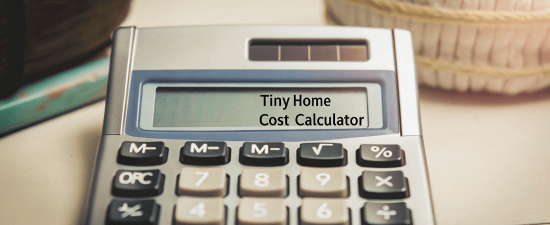 A close up photo of a Tiny Home Cost Calculator a type of electronic device with a screen displaying the text Tiny Home Cost Calculator and a keypad with a variety of buttons for mathematical operations The calculator is predominantly silver with a keypad featuring black and some buttons with symbols The photo is taken from a slightly elevated angle focusing on the calculator and its features In the blurred background there is a textured beige like object The style is a high resolution clear photograph