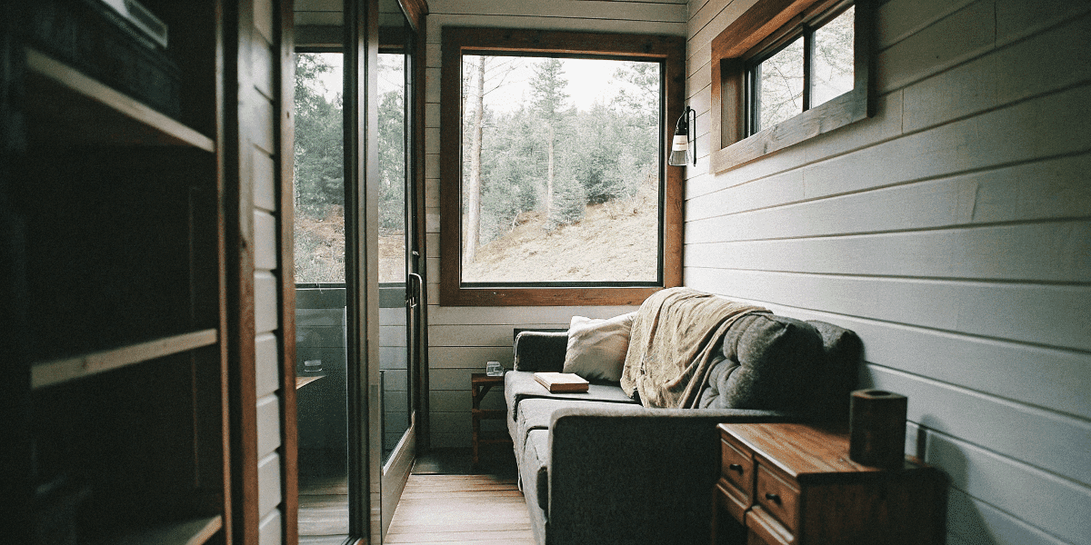 2753d883ef6d4fb885246f8cef4d150e Tiny house living room with natural light and cozy furnishings