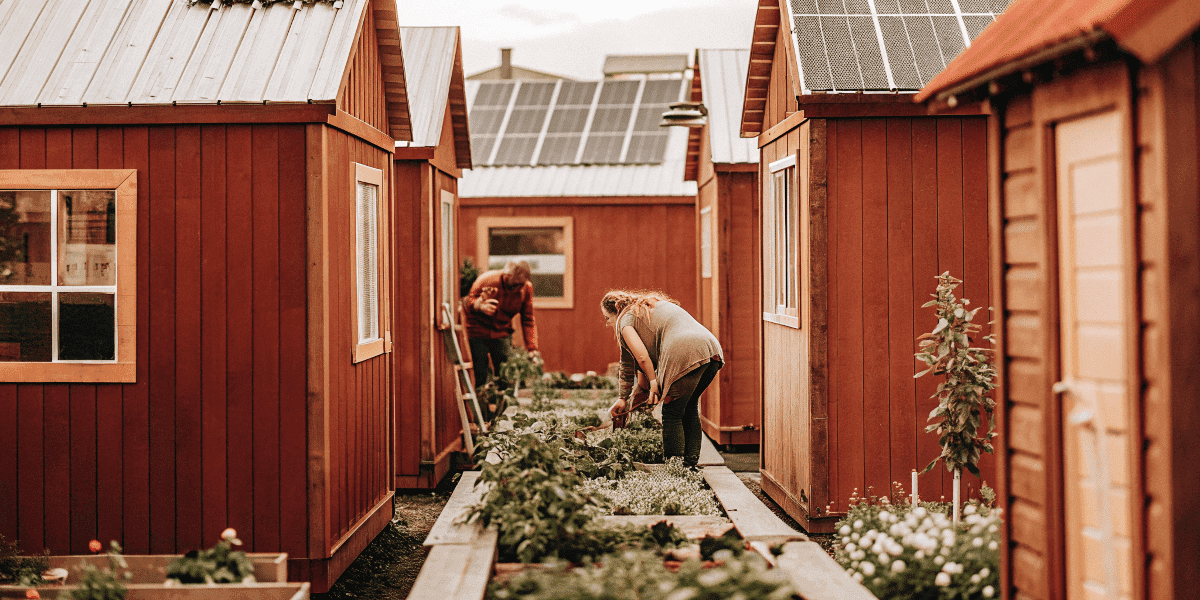 5bc1c7bd168548708fbb96bb012b092a Community garden shared by tiny houses with residents gardening