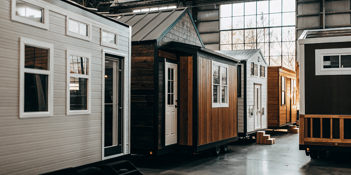 7b351da0fba04572b9a973b87777e34a Diverse tiny home models in a tiny home store showroom