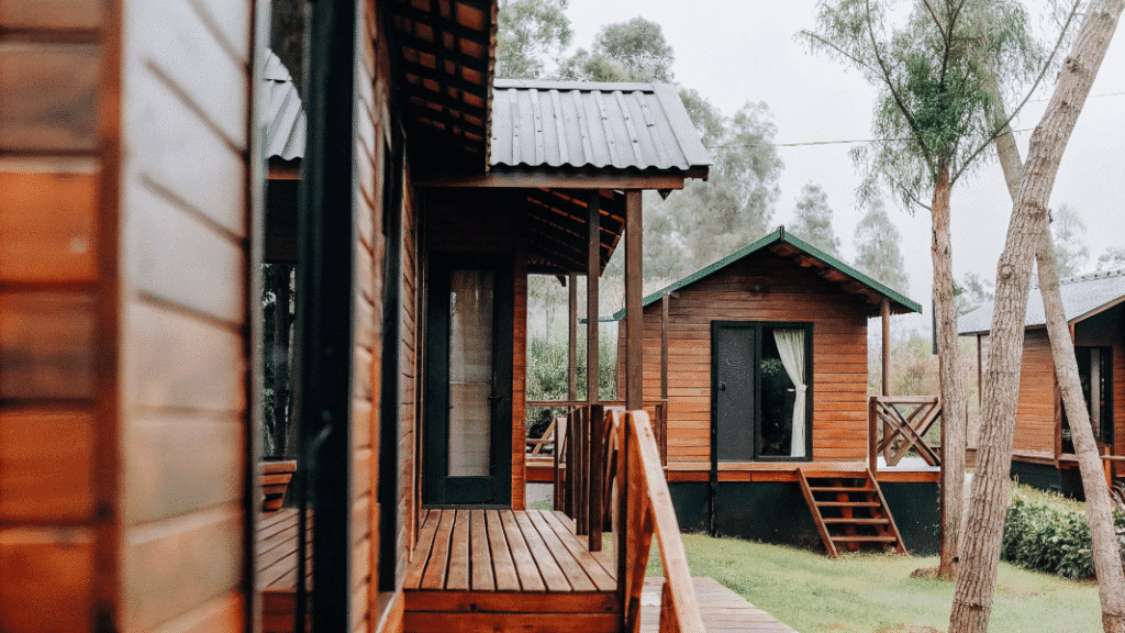 Modularcottage A photograph capturing a serene natural scene with a rustic wooden structure in a wooded area The image showcases a traditional wooden house with a simple design