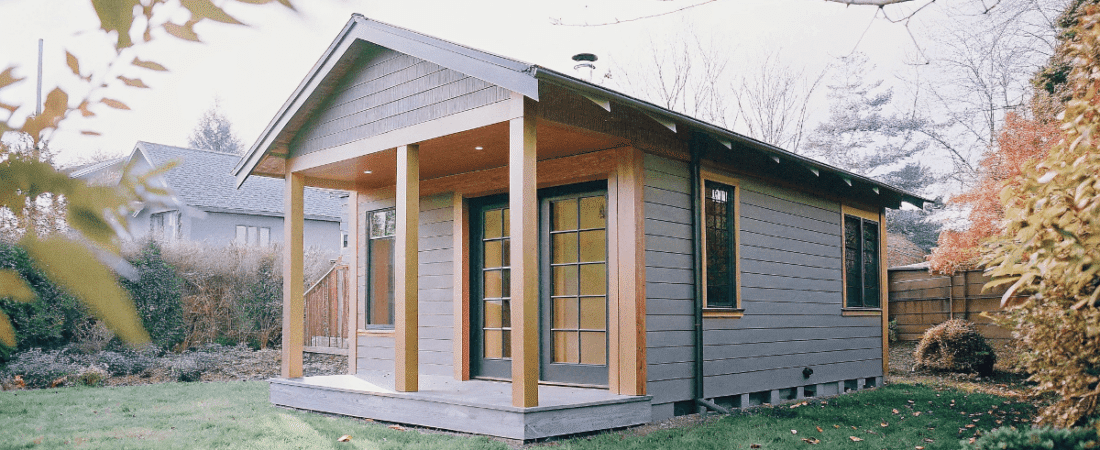 A modern granny pod nestled in a green backyard showcasing a harmonious blend of nature and innovation