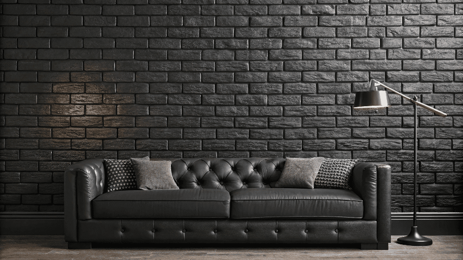 Blackbricklookwallpaper Black Brick looking wallpaper next to a black sofa