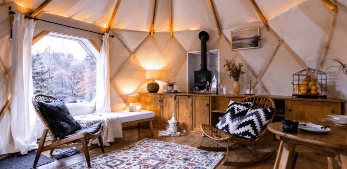9fa2771a93d34624bffc0c53c9284133 Interior of a yurt cabin with chair table and bed