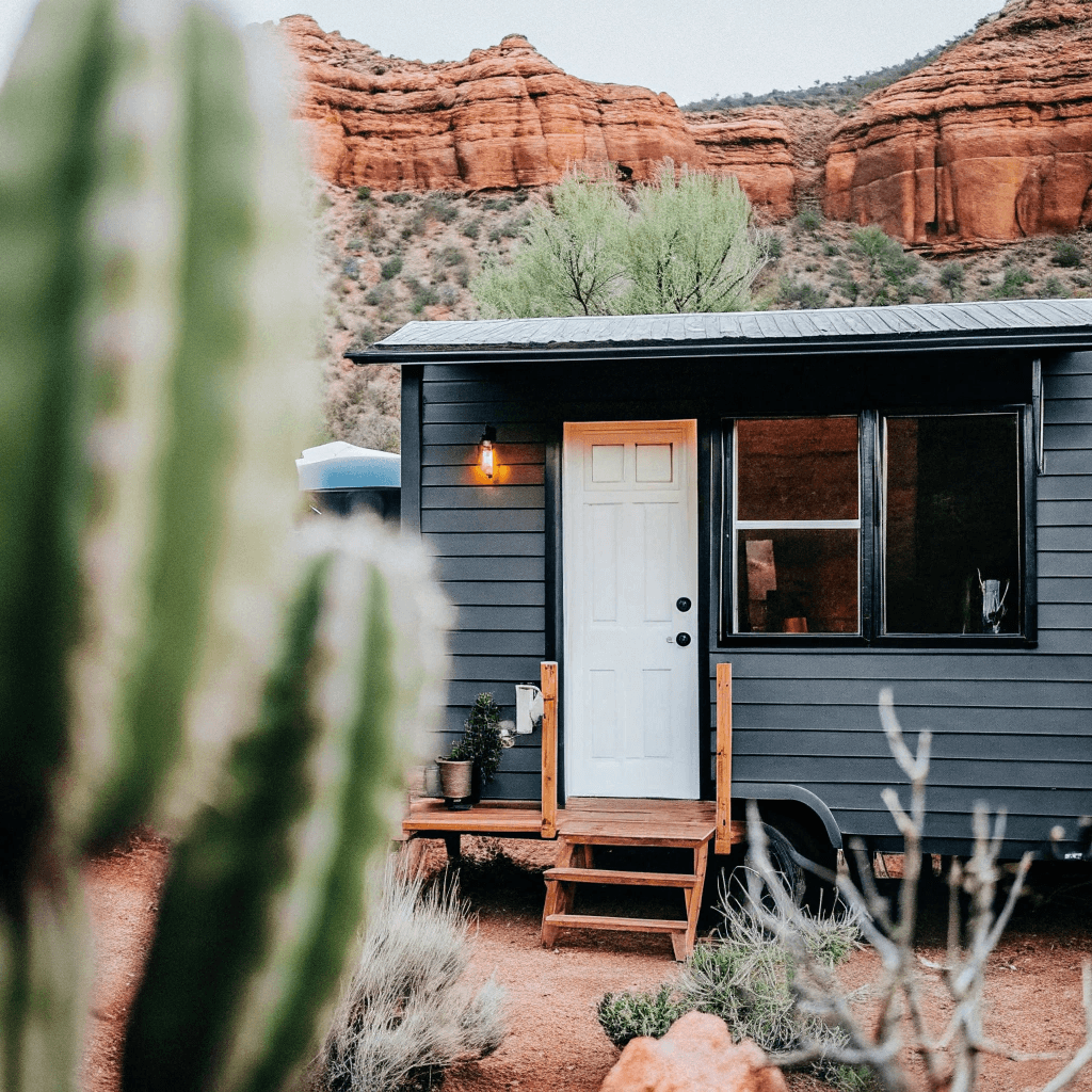 Tiny house in the dessert Tiny desert home with sand rocks and cactus nearby
