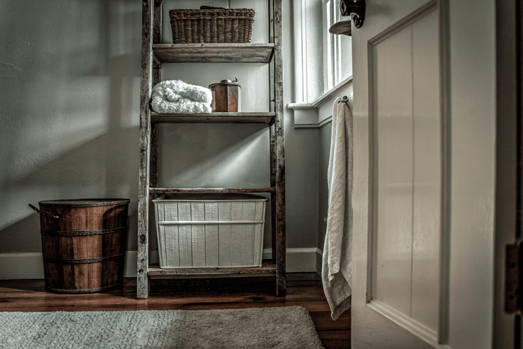 Cozy farmhouse laundry room corner with repurposed vintage furniture and DIY decor
