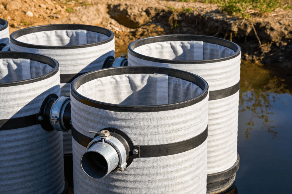 The image showcases an Advanced Enviro Septic System featuring a series of advanced enviro septic pipes lined with geotextile fabric designed to treat wastewater efficiently by removing up to 99 of contaminants This innovative system is compact and can be installed close to the Seasonal High Water Table making it a flexible solution for property owners with varying site conditions