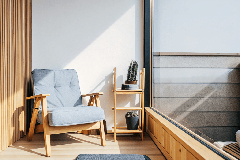 Go tiny clear mind Photograph of a minimalist bright and cozy reading nook featuring light colored furniture various green plants and natural wood accents creating a serene atmosphere