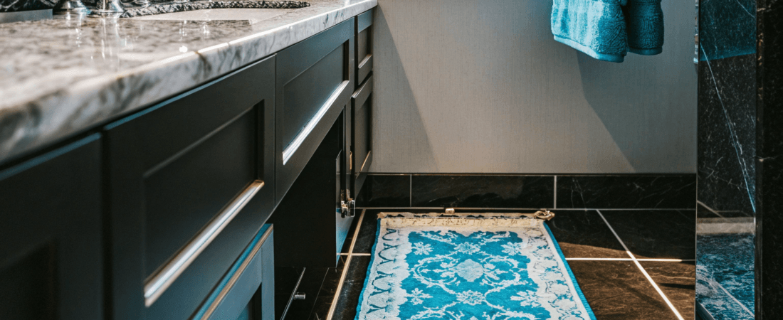 A luxury blue and black tiled small laundry room