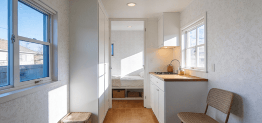 An interior of a white wallpaper timy home