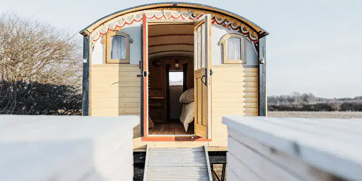Charming tiny house on wheels for sale Cozy tiny house with vintage design and open door scenic outdoor setting