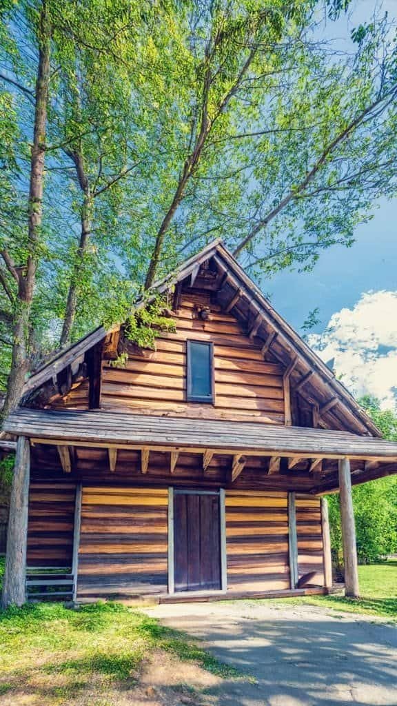 Charming tiny house in nature Charming Swedish tiny house with wooden exterior and lush green surroundings